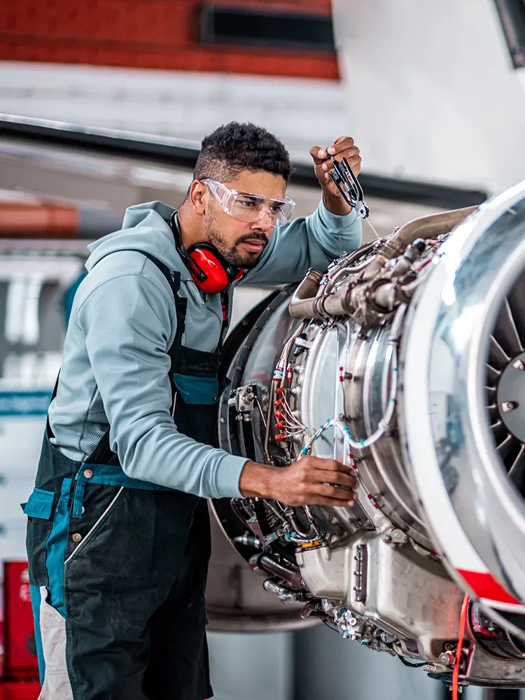 An engineer works on an aircraft.